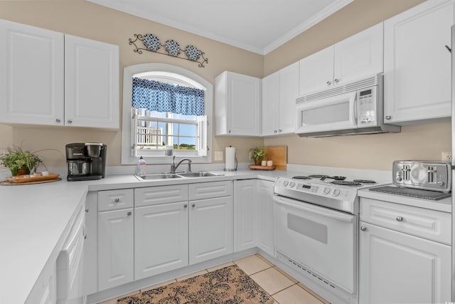 kitchen with sink, white cabinets, white appliances, and light tile patterned floors