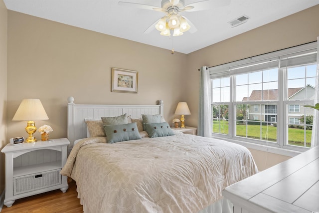 bedroom with light hardwood / wood-style flooring and ceiling fan