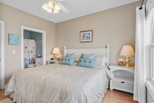 bedroom with ceiling fan, connected bathroom, and light wood-type flooring