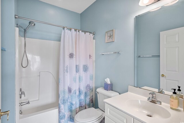 full bathroom with toilet, shower / tub combo with curtain, and vanity