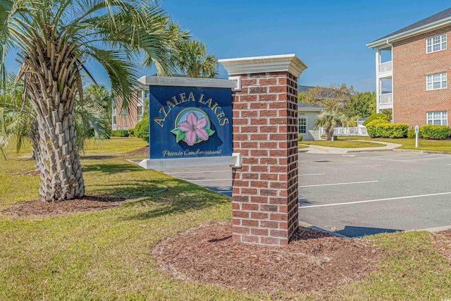 community sign featuring a yard