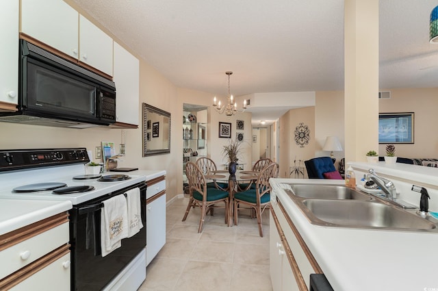 kitchen with white electric range, pendant lighting, light tile patterned floors, sink, and white cabinetry