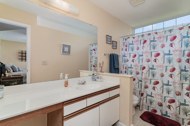 bathroom featuring curtained shower, vanity, a textured ceiling, toilet, and tile patterned floors