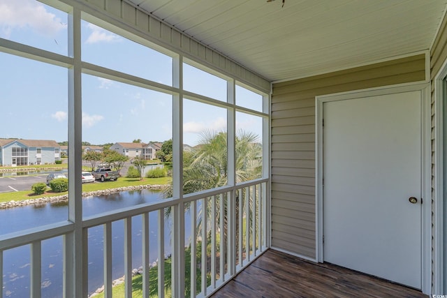 unfurnished sunroom with a water view