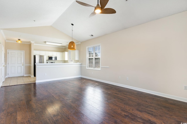unfurnished living room featuring vaulted ceiling, baseboards, visible vents, a ceiling fan, and wood finished floors
