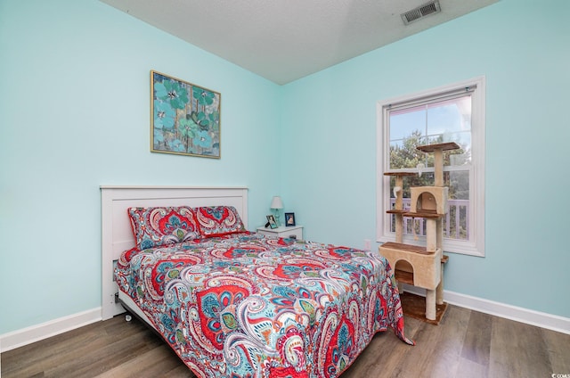 bedroom with hardwood / wood-style floors