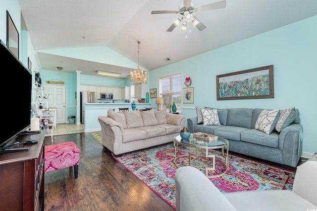 living room featuring ceiling fan with notable chandelier, dark tile patterned flooring, and high vaulted ceiling