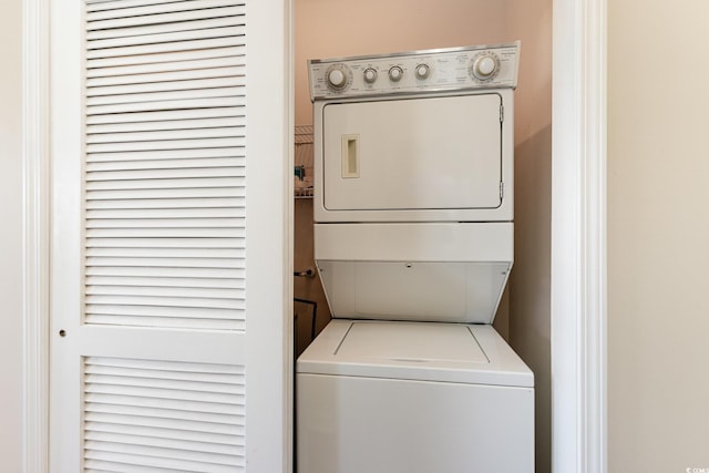 laundry room with stacked washer and dryer and laundry area