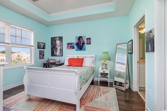 bedroom featuring ensuite bath, a raised ceiling, ornamental molding, and dark hardwood / wood-style floors