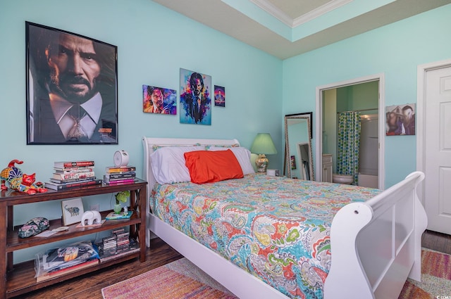 bedroom with connected bathroom, crown molding, and wood-type flooring