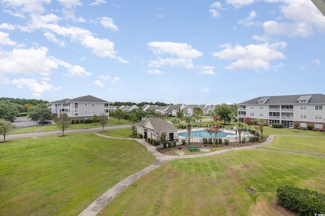 exterior space with a swimming pool and a yard