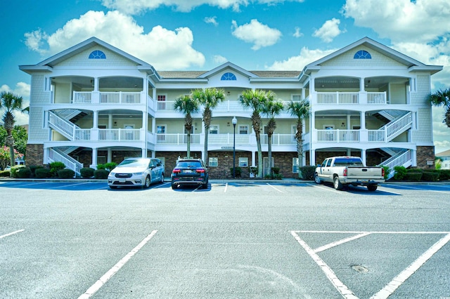 5801 Oyster Catcher Dr Unit 434, North Myrtle Beach, SC 29582 - view of property with stairs and uncovered parking