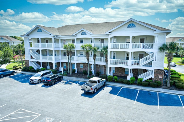 5801 Oyster Catcher Dr Unit 434, North Myrtle Beach, SC 29582 - view of apartment building / complex with uncovered parking and stairway