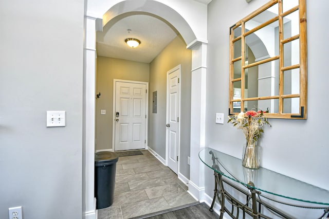 entryway featuring a textured ceiling and hardwood / wood-style floors