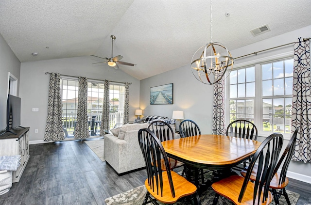 dining room featuring ceiling fan with notable chandelier, dark wood-type flooring, and a healthy amount of sunlight