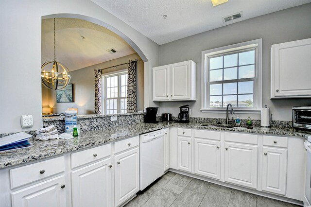 5801 Oyster Catcher Dr Unit 434, North Myrtle Beach, SC 29582 - kitchen featuring dishwasher, a chandelier, white cabinetry, light stone countertops, and arched walkways