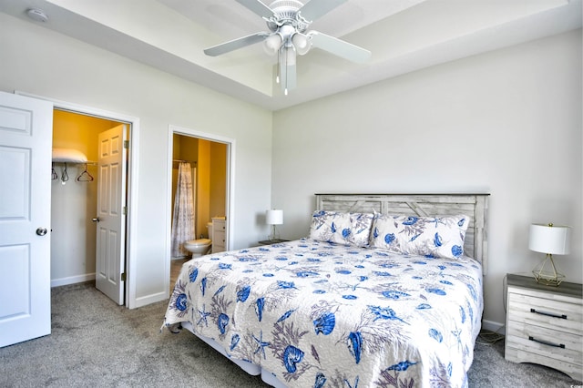 bedroom with ceiling fan, carpet flooring, and ensuite bath