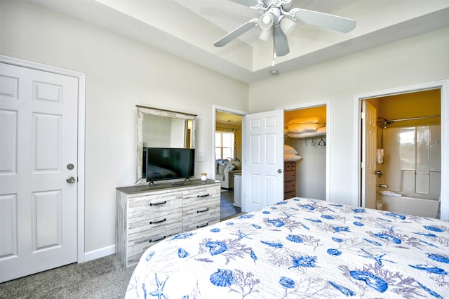 carpeted bedroom with ceiling fan, multiple windows, and connected bathroom