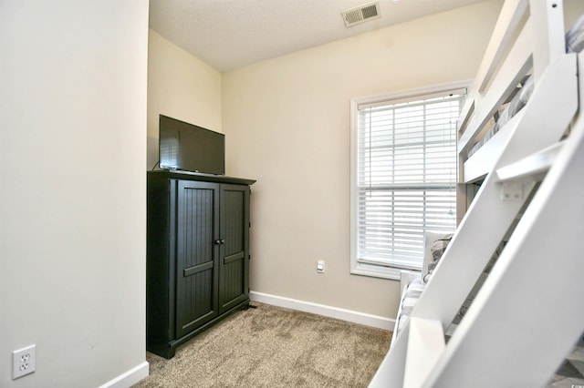 carpeted bedroom featuring multiple windows