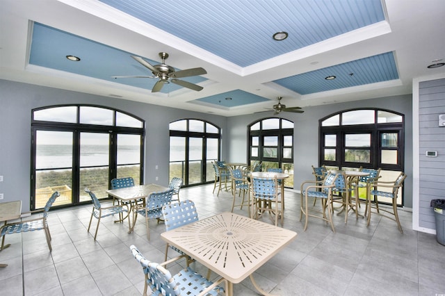 5801 Oyster Catcher Dr Unit 434, North Myrtle Beach, SC 29582 - dining area with a ceiling fan, coffered ceiling, a water view, a tray ceiling, and crown molding