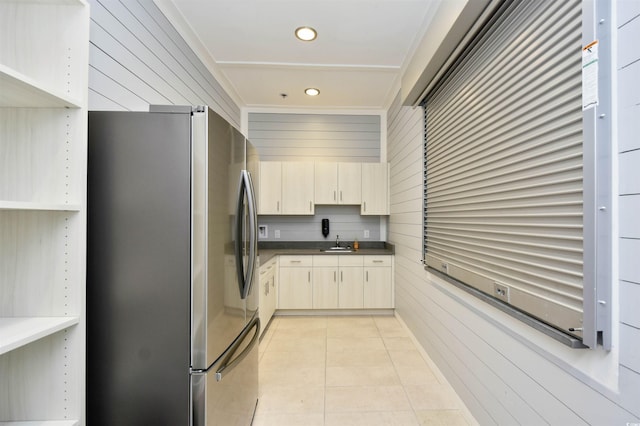 5801 Oyster Catcher Dr Unit 434, North Myrtle Beach, SC 29582 - kitchen with freestanding refrigerator, dark countertops, light tile patterned flooring, wood walls, and recessed lighting