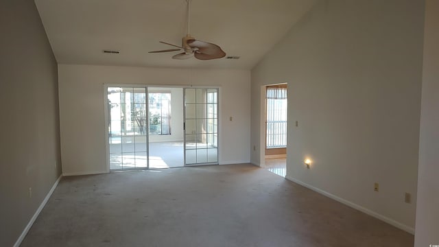 spare room with high vaulted ceiling, visible vents, and baseboards