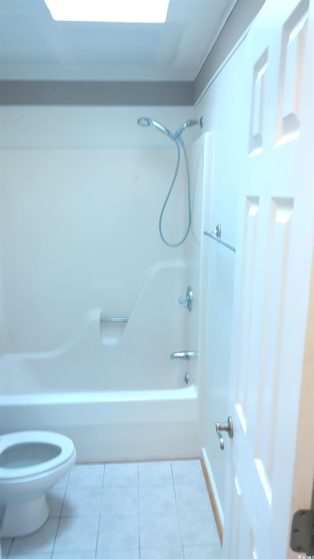 bathroom featuring tile patterned flooring, shower / tub combination, and toilet