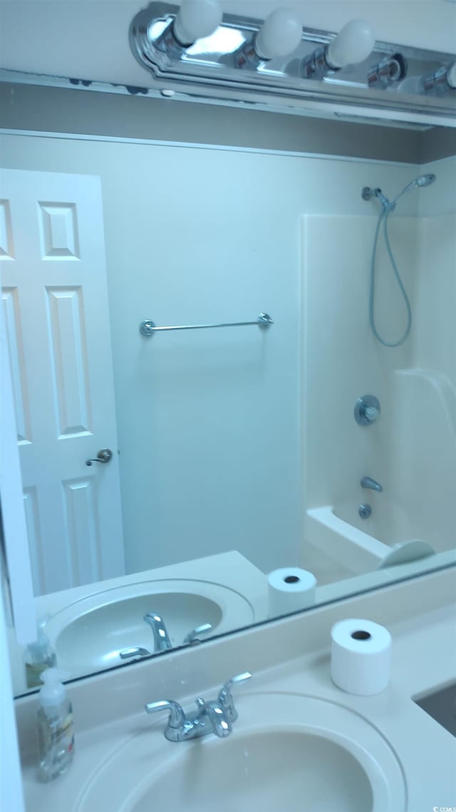 bathroom with  shower combination and a sink