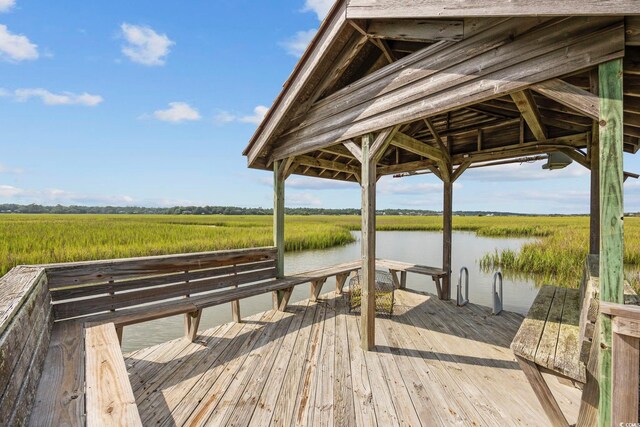 dock area featuring a water view and a rural view