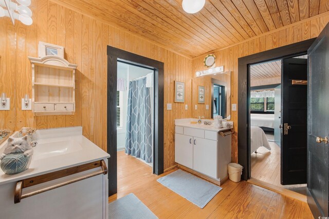 bathroom with wood walls, hardwood / wood-style flooring, wooden ceiling, and vanity