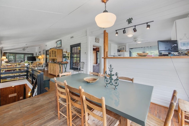 dining area with ceiling fan, hardwood / wood-style floors, and track lighting