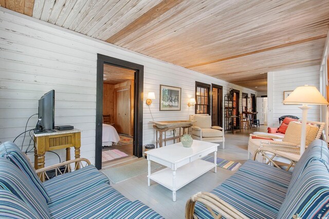 living room featuring wood ceiling, hardwood / wood-style flooring, and wooden walls