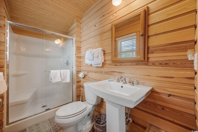 bathroom with wood ceiling, toilet, wooden walls, and a shower with shower door