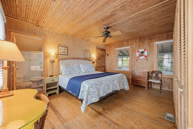 bedroom with hardwood / wood-style floors, wooden walls, and wooden ceiling