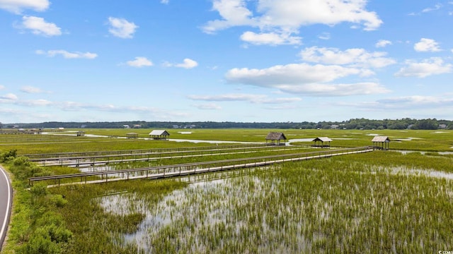 birds eye view of property featuring a water view and a rural view