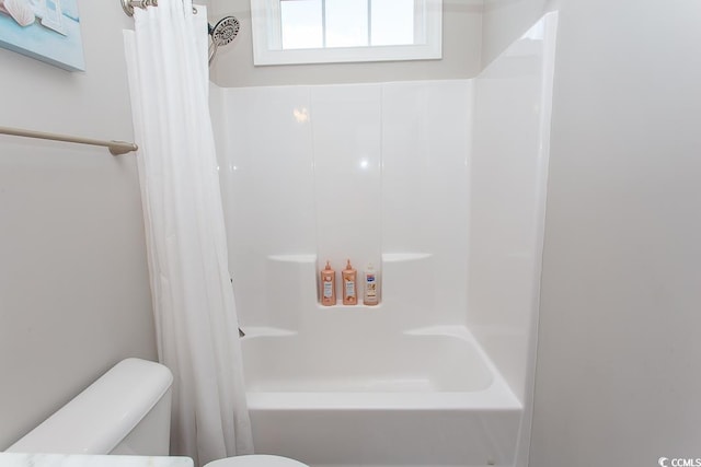 bathroom featuring shower / bath combo and toilet