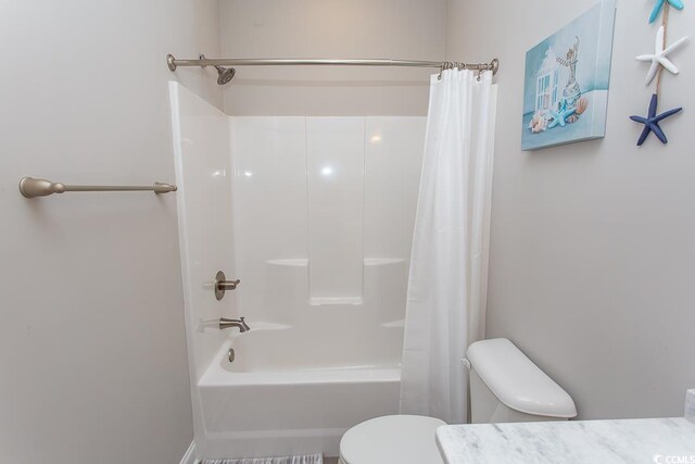 bathroom featuring shower / bath combo and toilet