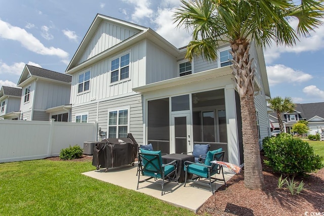 rear view of house featuring a lawn, central AC unit, and a patio area