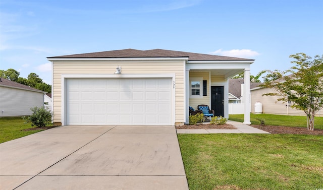 ranch-style house featuring a front yard and a garage