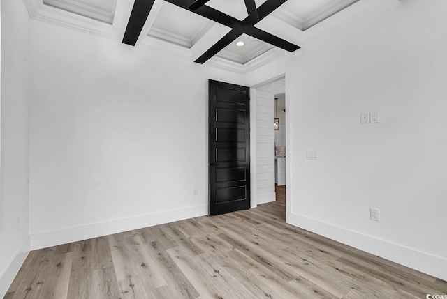 unfurnished room with beamed ceiling, ornamental molding, coffered ceiling, and light hardwood / wood-style floors