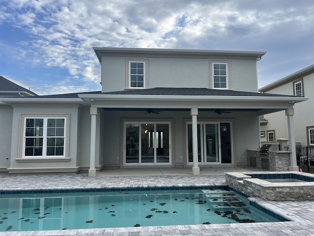 rear view of property with area for grilling, ceiling fan, a swimming pool with hot tub, and a patio