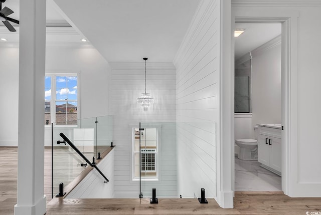 interior space featuring crown molding, an inviting chandelier, and light wood-type flooring