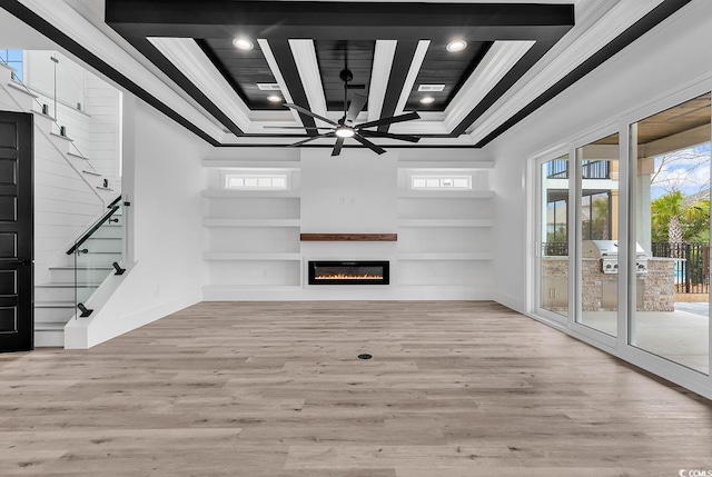 unfurnished living room with crown molding, light hardwood / wood-style flooring, built in shelves, and ceiling fan