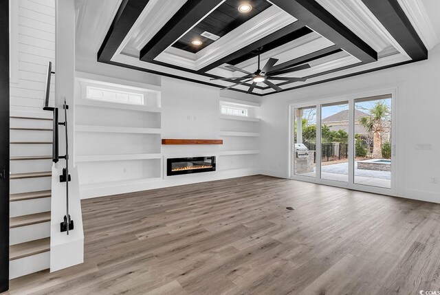 unfurnished living room featuring coffered ceiling, crown molding, wood-type flooring, and ceiling fan