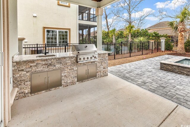 view of patio / terrace with area for grilling, sink, and a grill