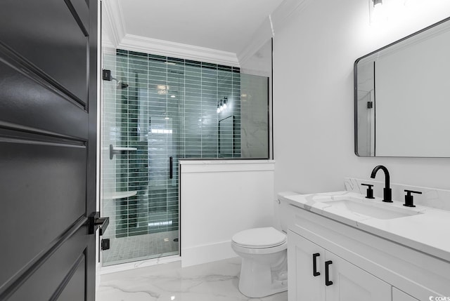 bathroom featuring crown molding, toilet, vanity, and a shower with shower door