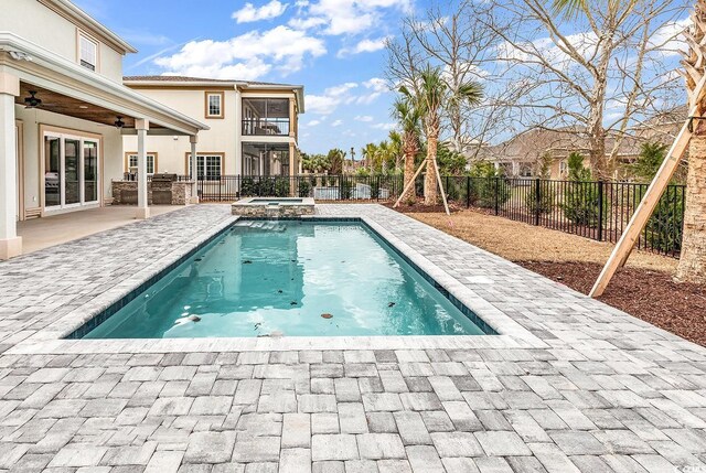 view of swimming pool featuring a patio area, ceiling fan, and an in ground hot tub