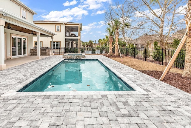 view of swimming pool with an in ground hot tub, ceiling fan, and a patio