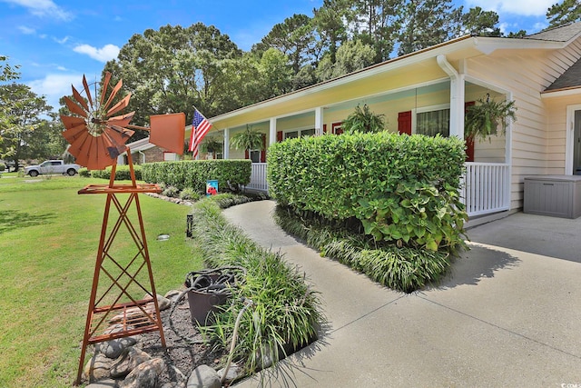 view of side of home with a lawn