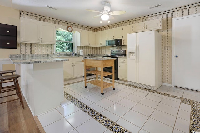 kitchen with light hardwood / wood-style flooring, decorative backsplash, range with electric cooktop, white refrigerator with ice dispenser, and ceiling fan